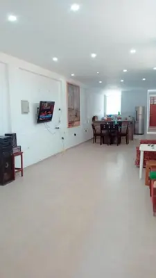 a living room with a white floor and tables and chairs at CASITA PARA FIN DE SEMANA in Rancho Cesar