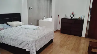 a bedroom with a bed and a bath tub at CASITA PARA FIN DE SEMANA in Rancho Cesar