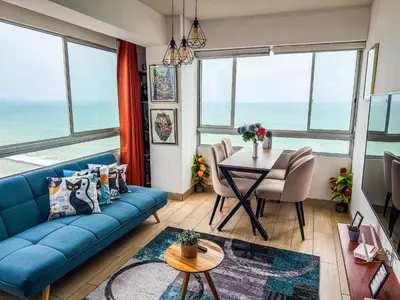 a living room with a blue couch and a table at Departamento exclusivo con vista al mar in Lima