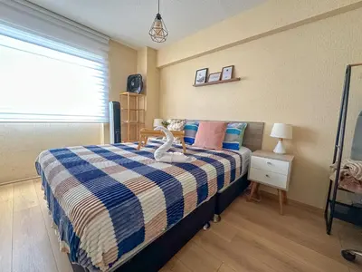 a bedroom with a bed with a blue and white blanket at Departamento exclusivo con vista al mar in Lima