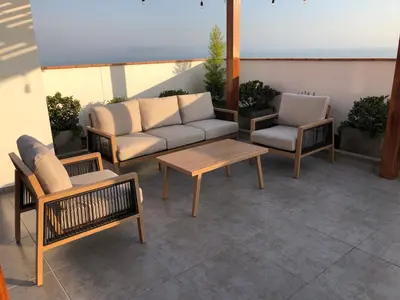 a patio with a couch and two chairs and a table at Departamento exclusivo con vista al mar in Lima