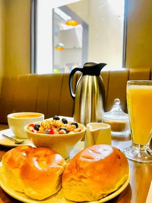 a table topped with bread and a bowl of breakfast food at CASA MONTES PARDO in Cusco