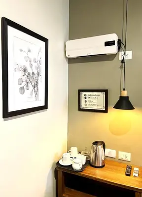 a room with a table with a coffee pot and a fan at CASA MONTES PARDO in Cusco