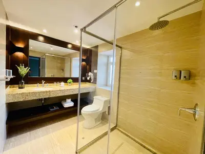 a bathroom with a toilet and a glass shower at CASA MONTES PARDO in Cusco