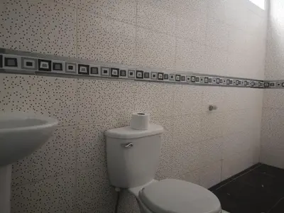 a bathroom with a white toilet and a sink at Mi Chanchamayo, family. in La Merced