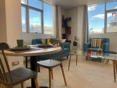 a living room with a table and chairs and a couch at Huancayo Suite 3, cómodo MiniDpto cama matrimonial in Huancayo