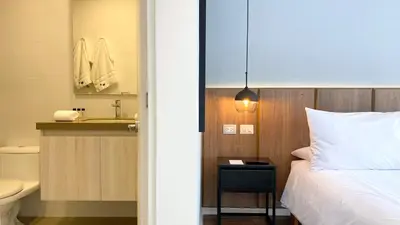 a bedroom with a bed and a bathroom with a sink at Actual by Wynwood House in Lima