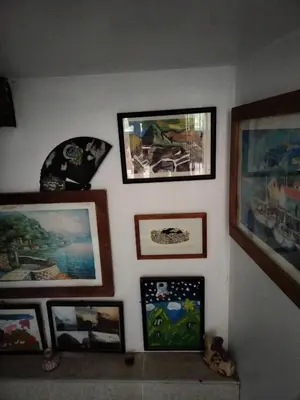 a wall with paintings and pictures on it at ECO ART Best view Machu Picchu in Machu Picchu