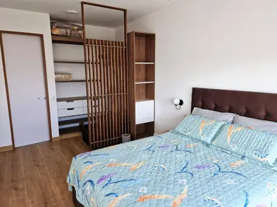 a bedroom with a large bed and a closet at VK Loft - Apartamento en Miraflores in Lima