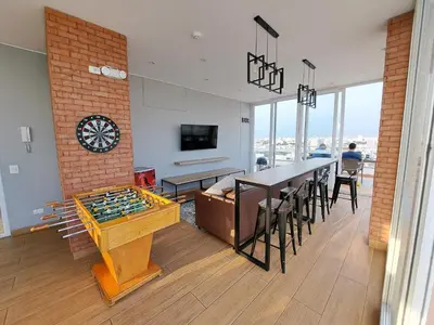 a living room with a table and a chess board at VK Loft - Apartamento en Miraflores in Lima