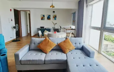 a living room with a blue couch with pillows at VK Loft - Apartamento en Miraflores in Lima