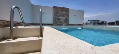 a swimming pool with a fountain on top of a building at L & P Apart Punta Hermosa in Punta Hermosa