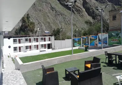 a patio with tables and chairs and a building at RONALD HOTEL in Churín