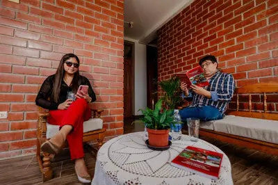 a man and a woman sitting in a brick wall at Las Yungas Hospedaje in Oxapampa