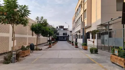 an empty street in a city with buildings at Paiva in Lima