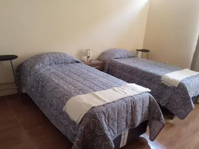 two beds in a hotel room with two beds sidx sidx sidx at Paiva in Lima