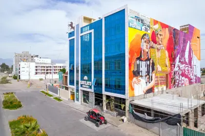 a building with a mural on the side of it at Hotel Savilayo in Ica
