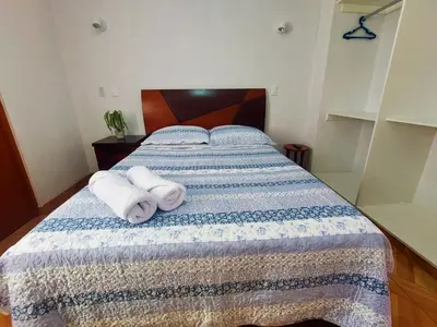 a bedroom with a bed with towels on it at Kasanty House in Paracas