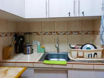 a kitchen with a sink and a counter top at Kasanty House in Paracas