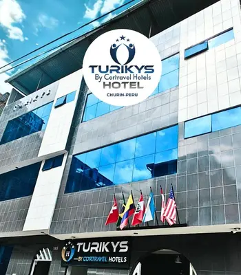 a building with a sign on the side of it at Hotel Turikys Churin in Churín