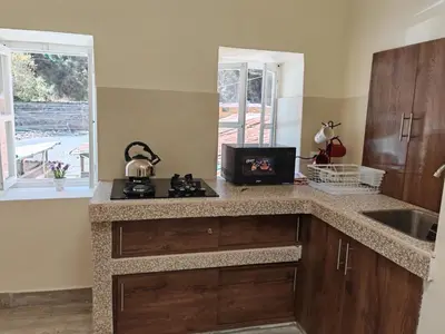 a kitchen with a sink and a counter with a stove at Centro Cusco Inti in Cusco