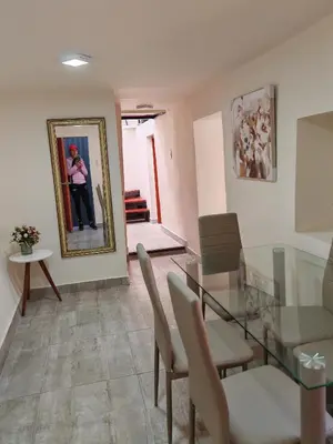 a dining room with a glass table and a woman in a mirror at Centro Cusco Inti in Cusco
