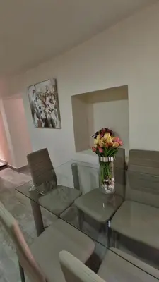 a living room with a vase of flowers on a table at Centro Cusco Inti in Cusco