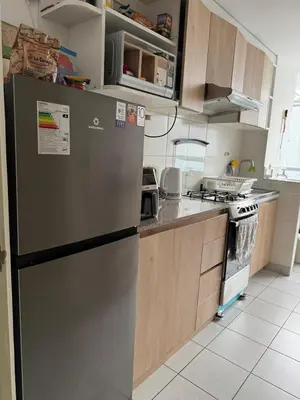 a kitchen with a refrigerator and a stove at Lindo Apartamento en Condominio Privado in Lima