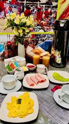 a table with plates of food on top at Hotel Valle Andino in Cusco