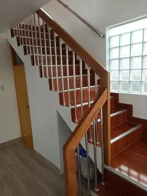 a wooden staircase in a room with a window at Hermosa y espléndida casa en Oxapampa in Oxapampa