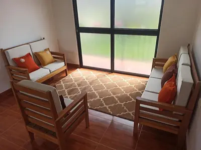 a living room with two chairs and a couch at Hermosa y espléndida casa en Oxapampa in Oxapampa