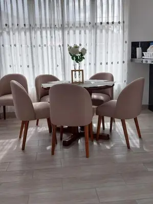 a dining room table and chairs with a vase of flowers on it at Hermosa y espléndida casa en Oxapampa in Oxapampa