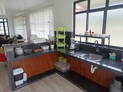 a kitchen with a sink and a counter top at Hermosa y espléndida casa en Oxapampa in Oxapampa