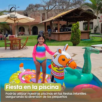 a young girl standing next to a toy horse in a pool at Hospedaje El Cascabel in Sunampe