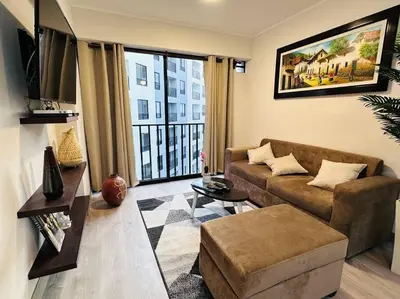 a living room with a couch and a large window at 2BR 2BTH San Isidro Apartment in Lima