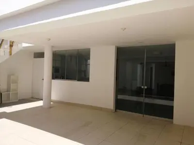 a white room with a pillar and glass doors at J&B Aparment 1 Punta Hermosa in Punta Hermosa