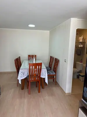 a dining room with a table and four chairs at Moderno Apartamento en Condominio Alto Venezuela in Lima