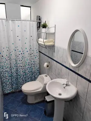 a bathroom with a toilet and a sink and a mirror at Casa Bonita in Lima