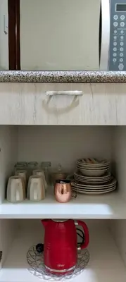 a red tea pot and plates on a shelf at Casa Bonita in Lima