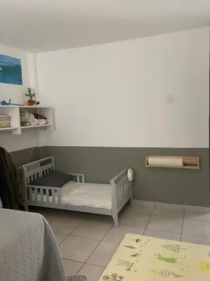 a childs bedroom with a crib in the corner at Watermanhouse, Punta Hermosa in Lima