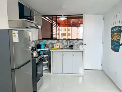a kitchen with a stainless steel refrigerator and white cabinets at San Miguel, 3 dormitorios, terraza wifi cochera in Lima