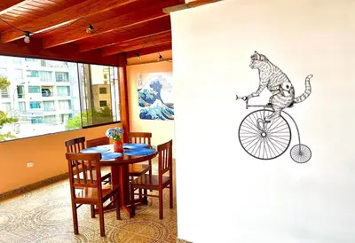 a cat riding a bike painted on a wall at San Miguel, 3 dormitorios, terraza wifi cochera in Lima