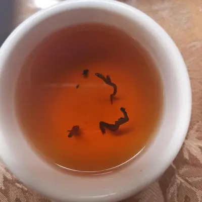 a cup of tea with a smiley face in it at la casa de mamá in Huayopata