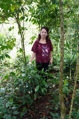 a young girl walking down a trail in the woods at la casa de mamá in Huayopata