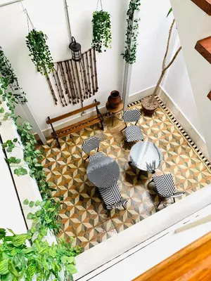 a room with chairs and tables on a tiled floor at Casa Porta in Lima
