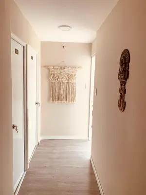 a hallway with a white wall and a window at Casa Porta in Lima
