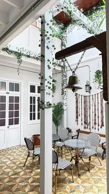 a patio with a table and chairs at Casa Porta in Lima