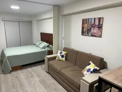 a living room with a couch and a bed at Moderno mini departamento de estreno in Lima