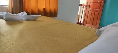 a bed with two pillows sitting on top of it at Casa D´Maria in Ollantaytambo