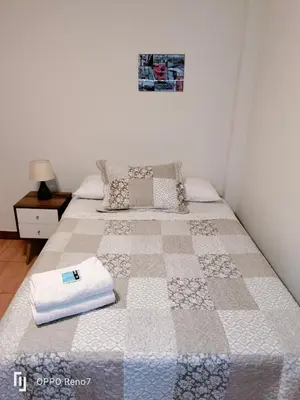 a bed with a quilt on it in a bedroom at Warmisitay H O M E in Lima